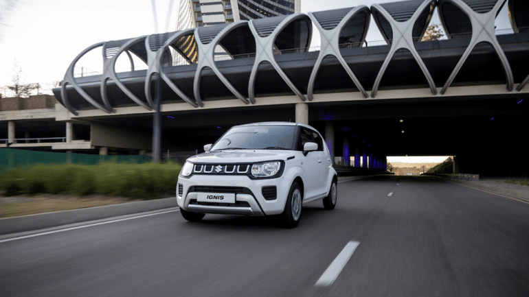 White Suzuki Ignis driving on the road 