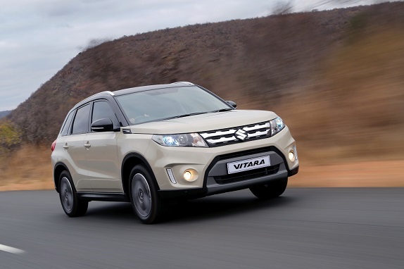 Beige Suzuki Vitara driving on the road  