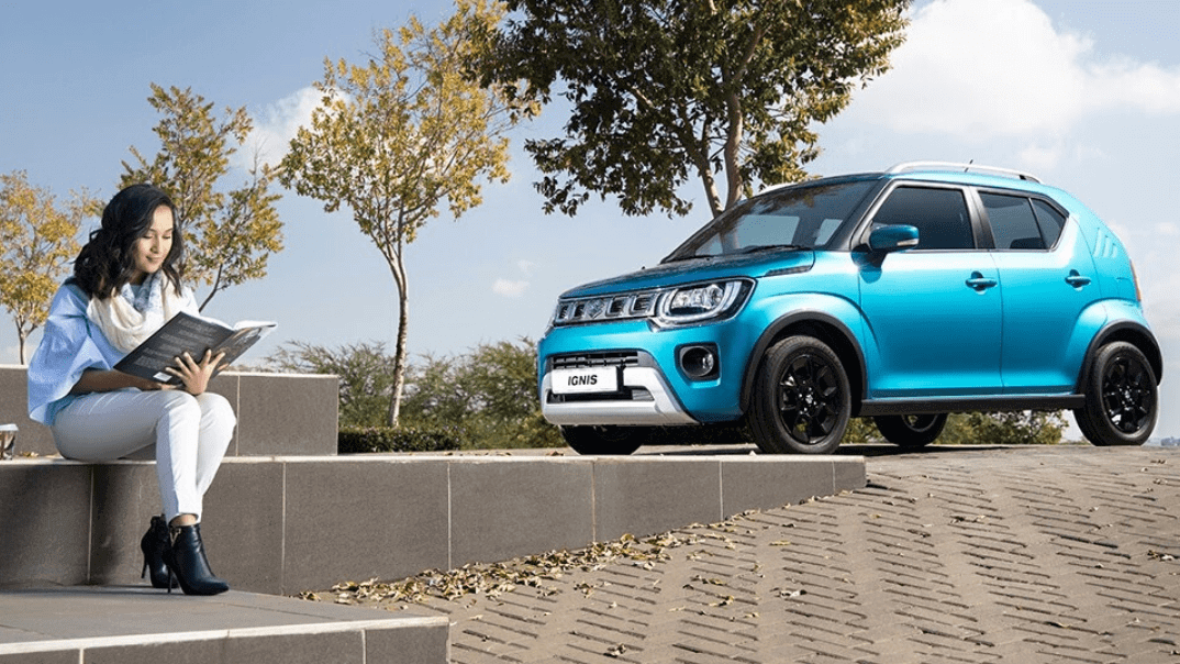 Parked Suzuki Ignis Blue woman reading 