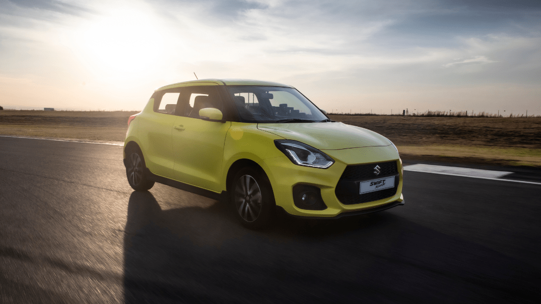 yellow Suzuki Swift Sport on the track