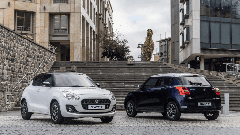 Black and white Suzuki swift on bottom of stairs