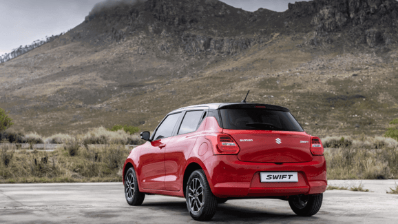 suzuki swift parked with a view of a mountain