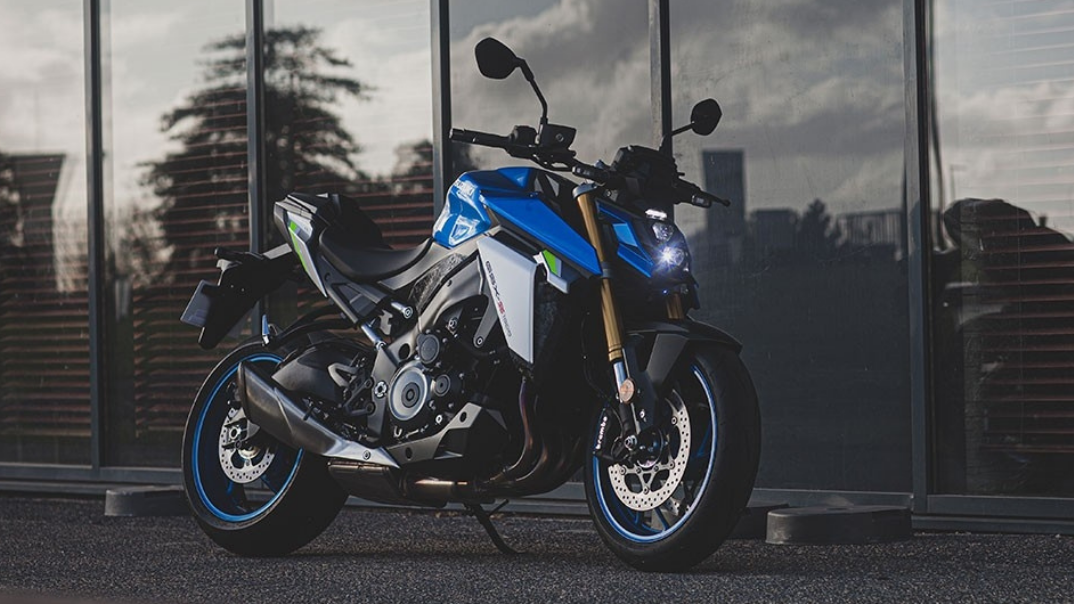 The New Suzuki GSX-S1000 Blue and white parked in front of glass windows