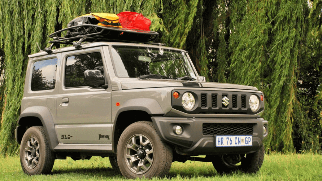 Suzuki Jimny Accessories on the roof parked on green grass