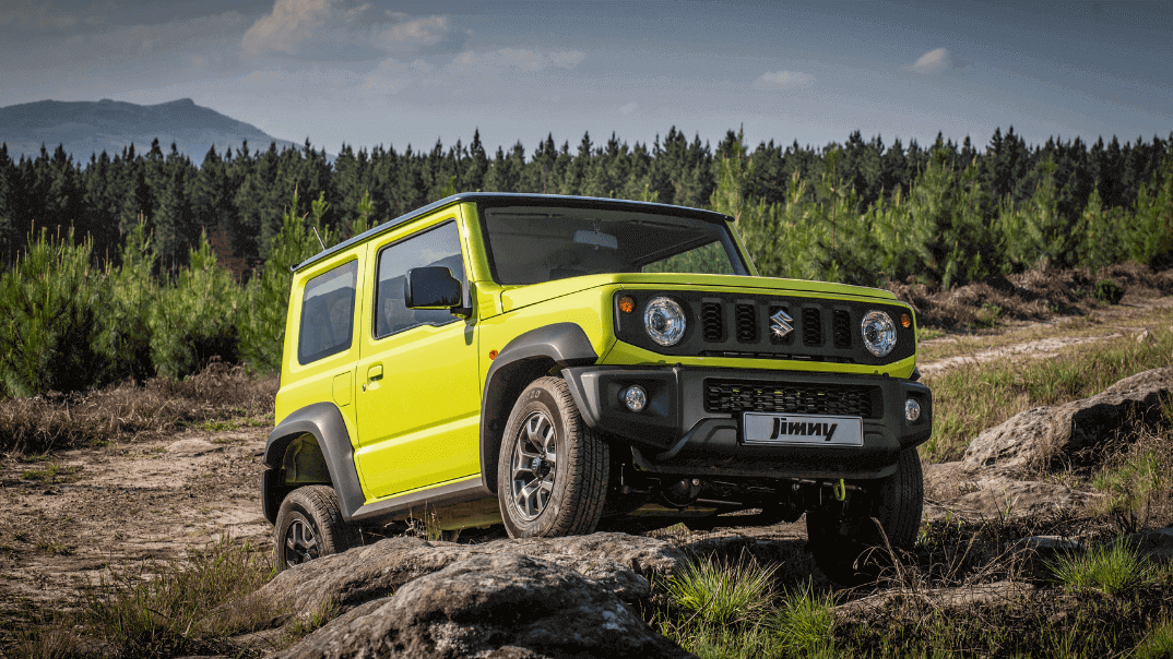 Suzuki Jimny Lime colour parked on rock 