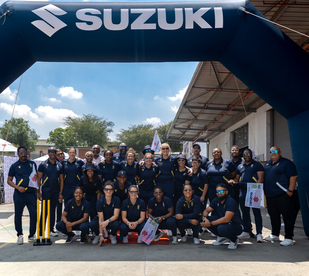CSA Women group photo under Suzuki sign 