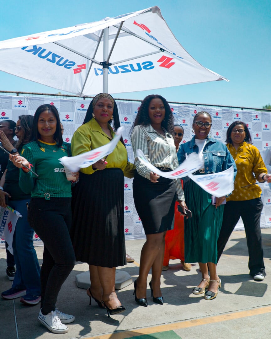A group of women under Suzuki Umbrella
