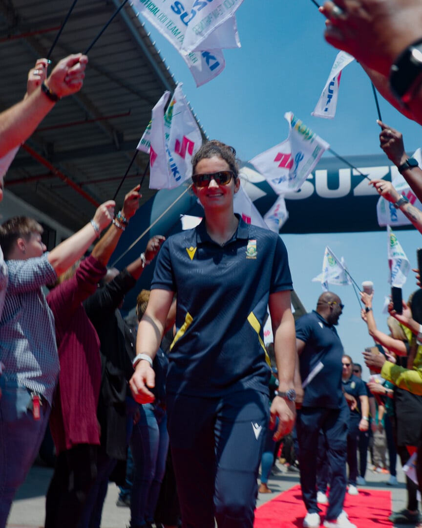 CSA Woman walking through cheering crowd