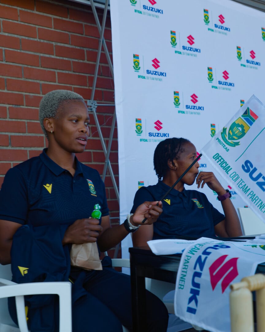 CSA Women in front of Suzuki banner 