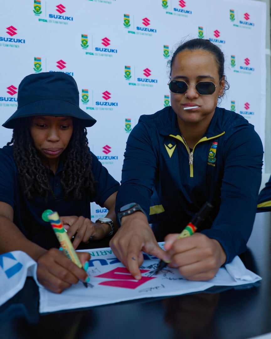 CSA Women signing Suzuki flag 