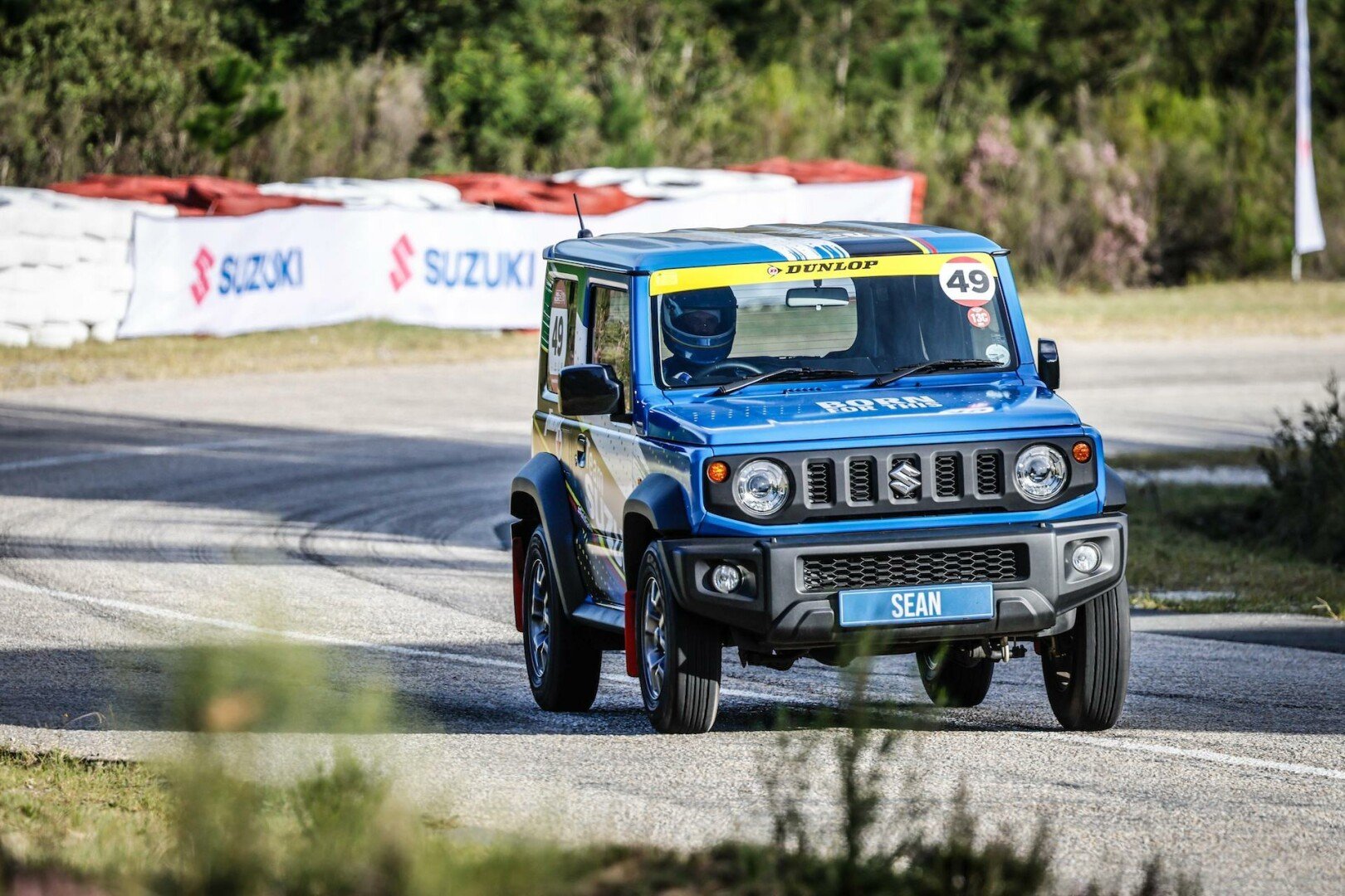 Blue Suzuki Jimny on the track 